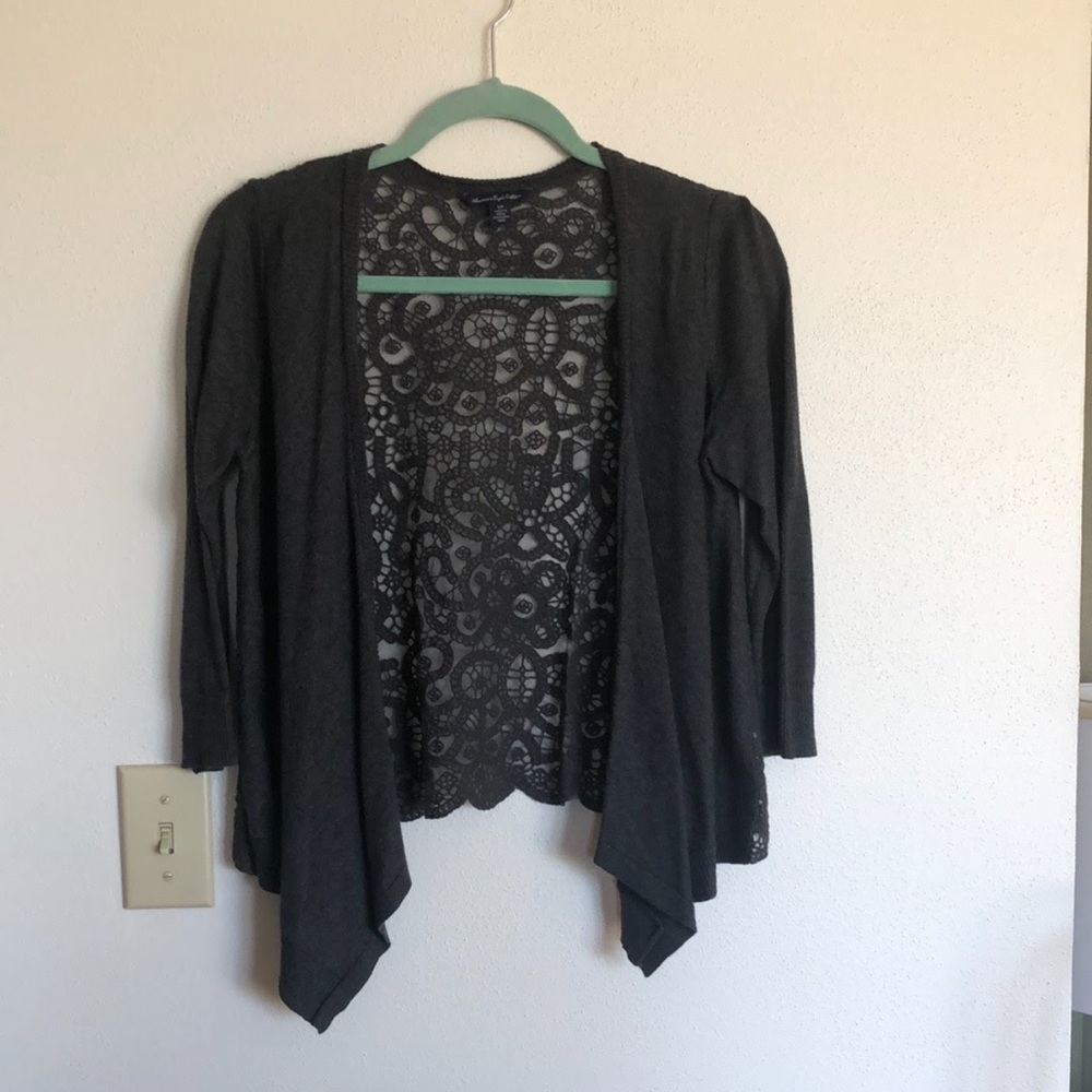 Light woman’s cardigan, sheer back, 3/4 length sleeves.